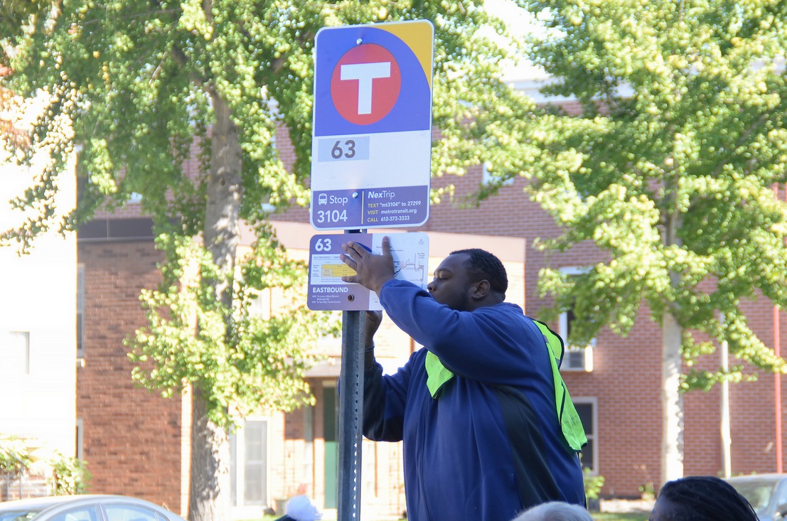 A new Metro Transit bus stop sign is installed on Grand Avenue in St. Paul on Tuesday, Oct. 13, 2015.