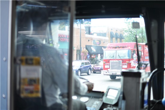 A bus driver watches as a firetruck passes by during a Metro Transit safety training course.