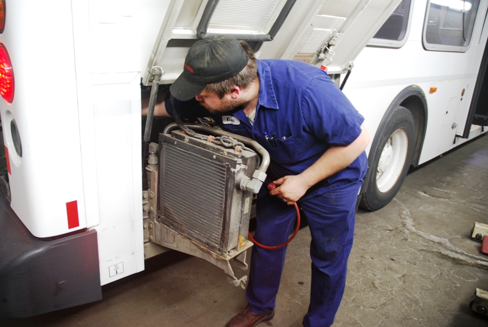 Mechanic-technician Kevin Hendrickson checks the heating and cooling system on a Metro Transit Bus.