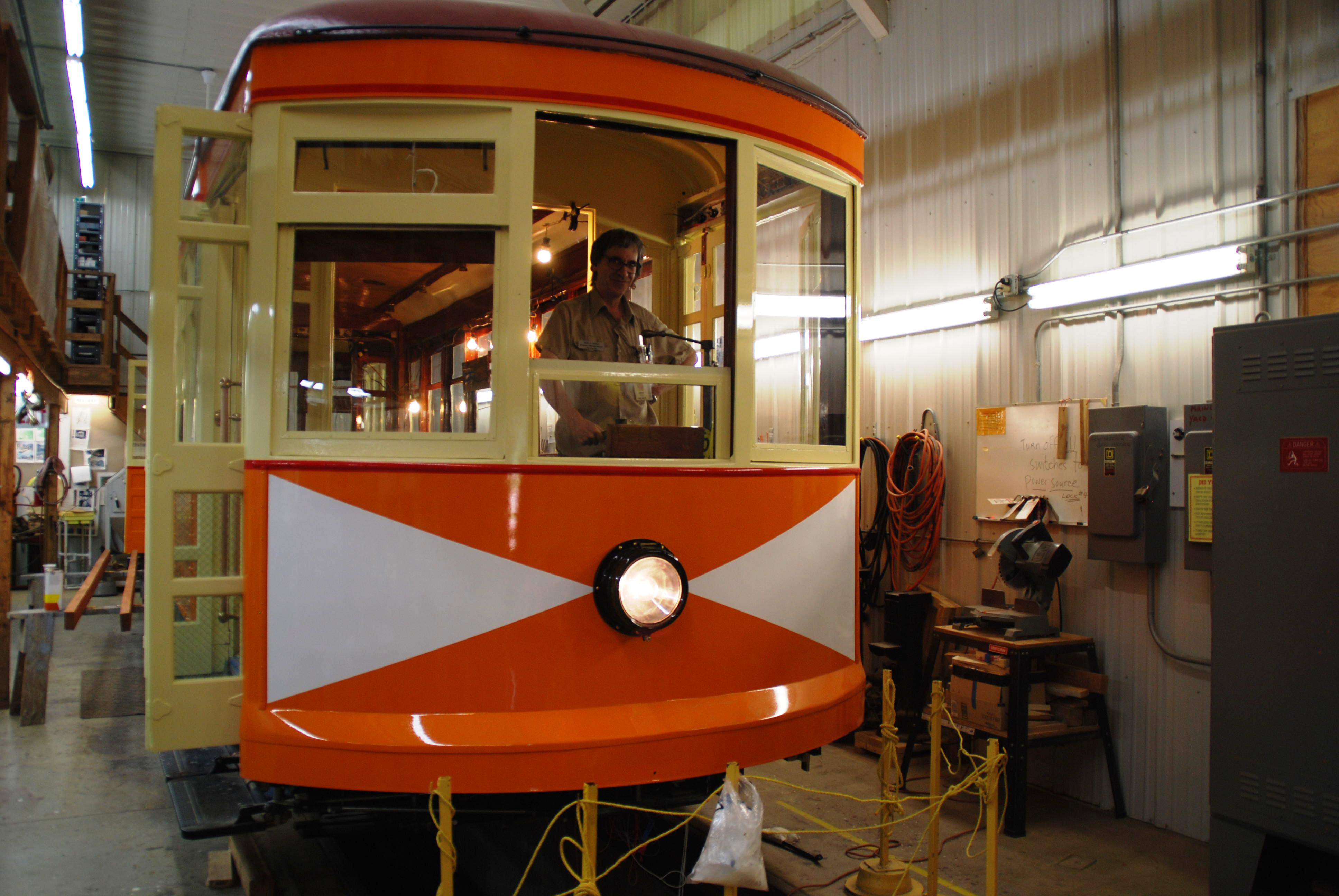 Signals Foreperson Mike Miller inside the Winona Streetcar No. 10 currently being restored in Excelsior.