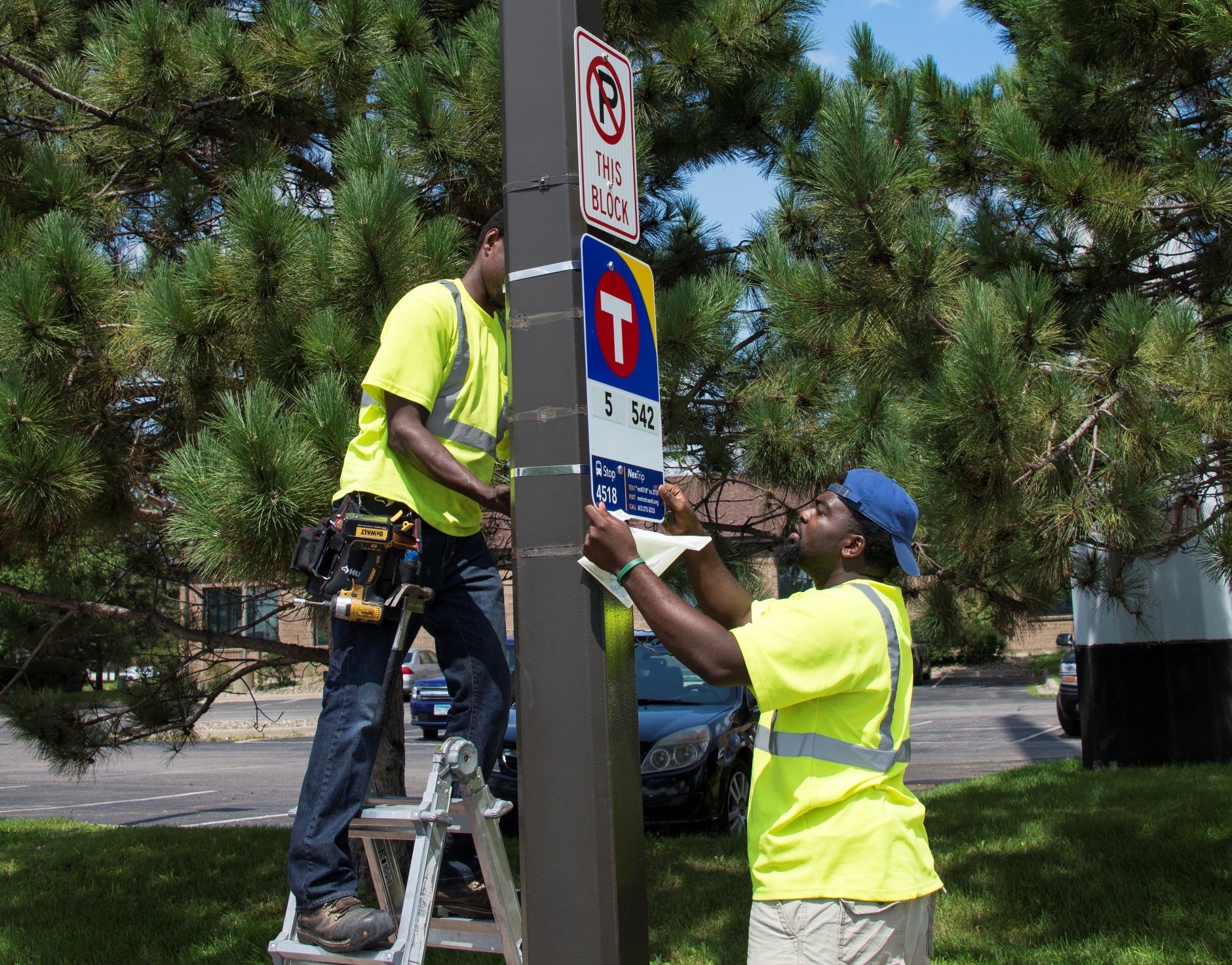 A new bus stop sign is installed on American Boulevard. 