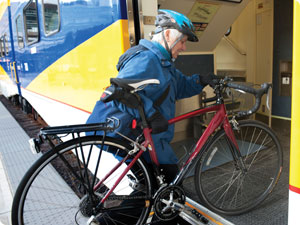 Bicyclist boarding train