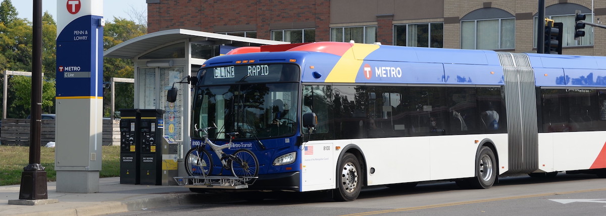 BRT station showing METRO C line approaching station.