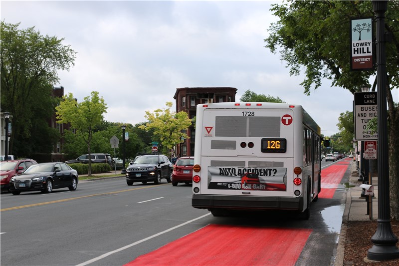 View along Hennepin Avenue showing a bus-only lane with red paint next to the curb. 