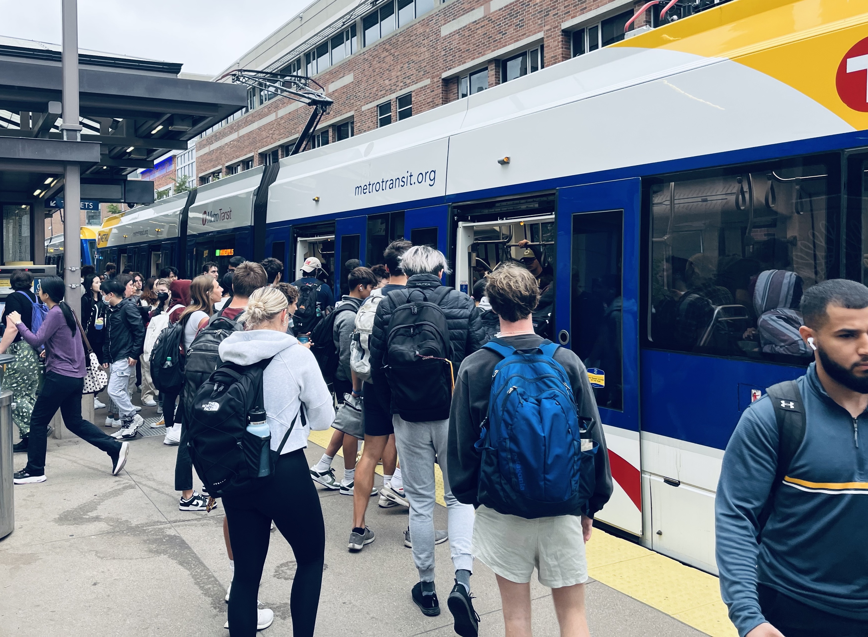 Students at the University of Minnesota board a Green Line train at the East Bank Station.