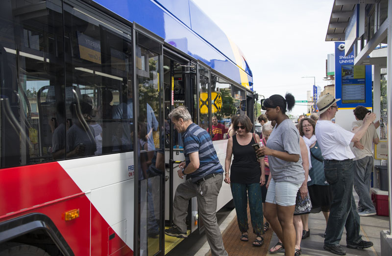 Customers board the A Line at Snelling and University avenues.