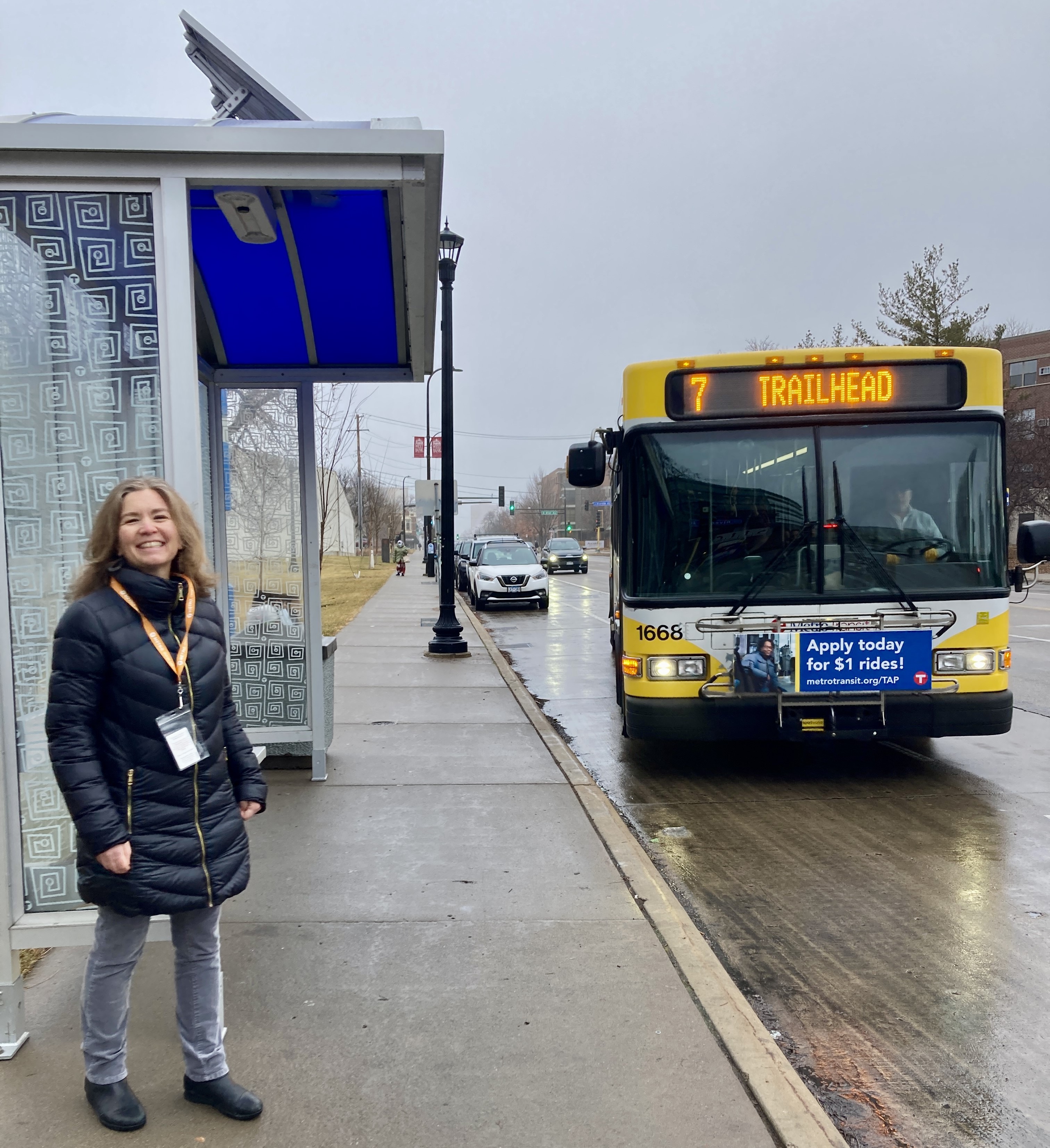 Berry Farrington, who works in Engineering & Facilities and manages the Better Bus Stops program, at a solar-powered bus shelter.