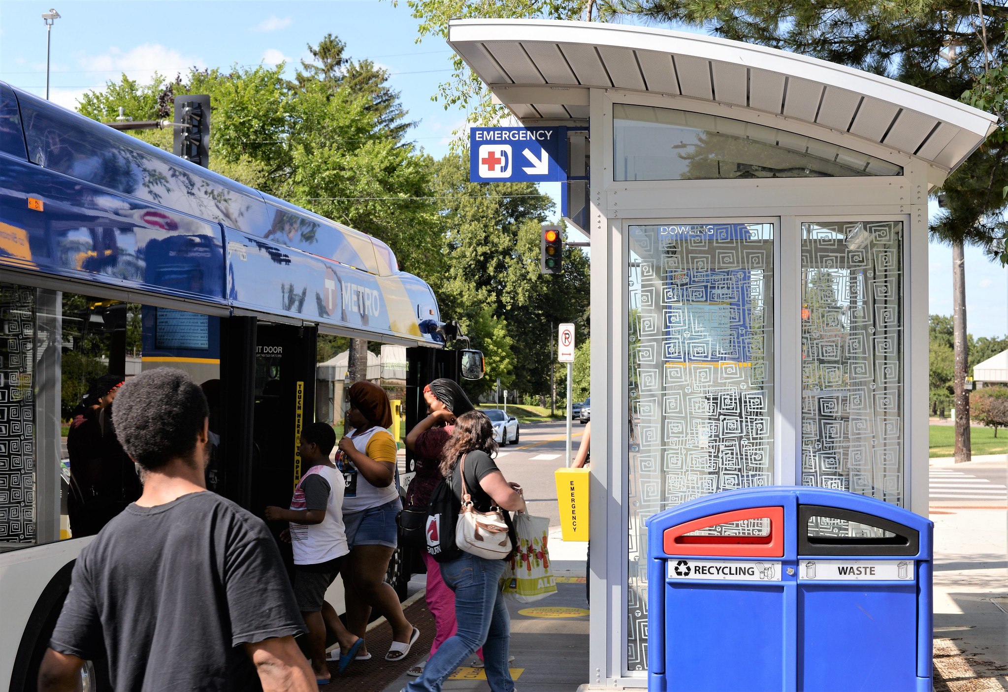Customers board a METRO C Line bus. 