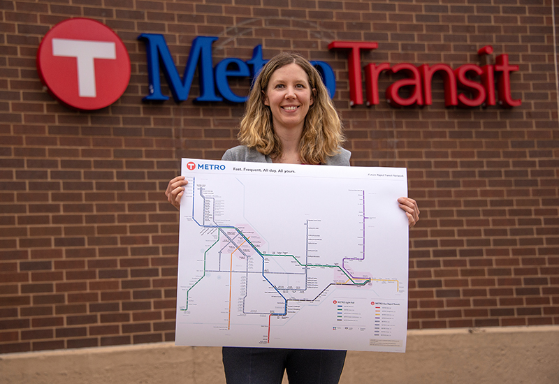 Senior Graphic Designer Leah Janz with the latest version of Metro Transit's METRO map.