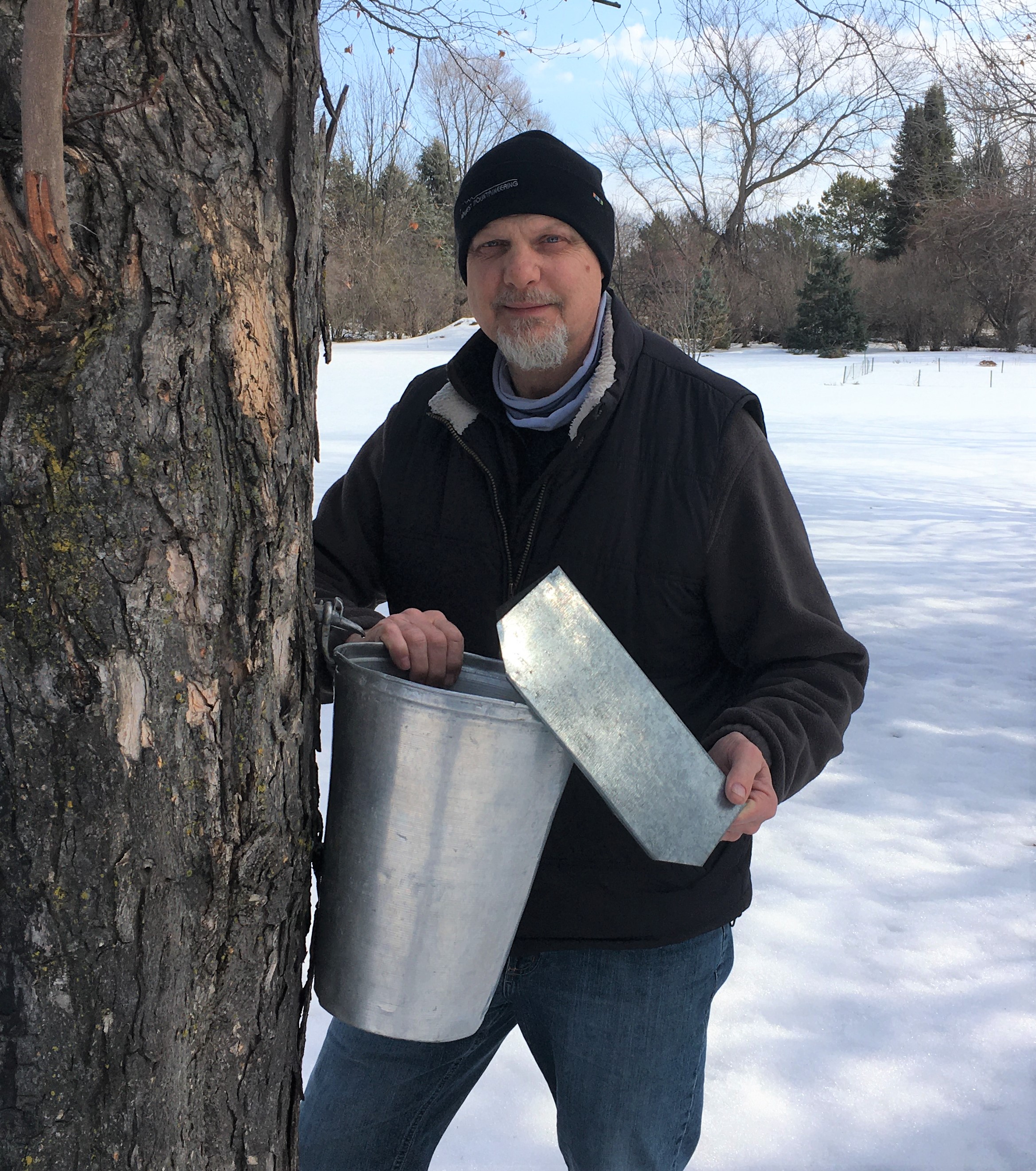 Mechanic Jon Christopherson tapping maple syrup at his home in Monticello.