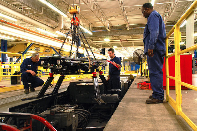 Electro mechanical technicians Tom Astedt and Chris Kostohris install ice cutters on a light-rail vehicle.