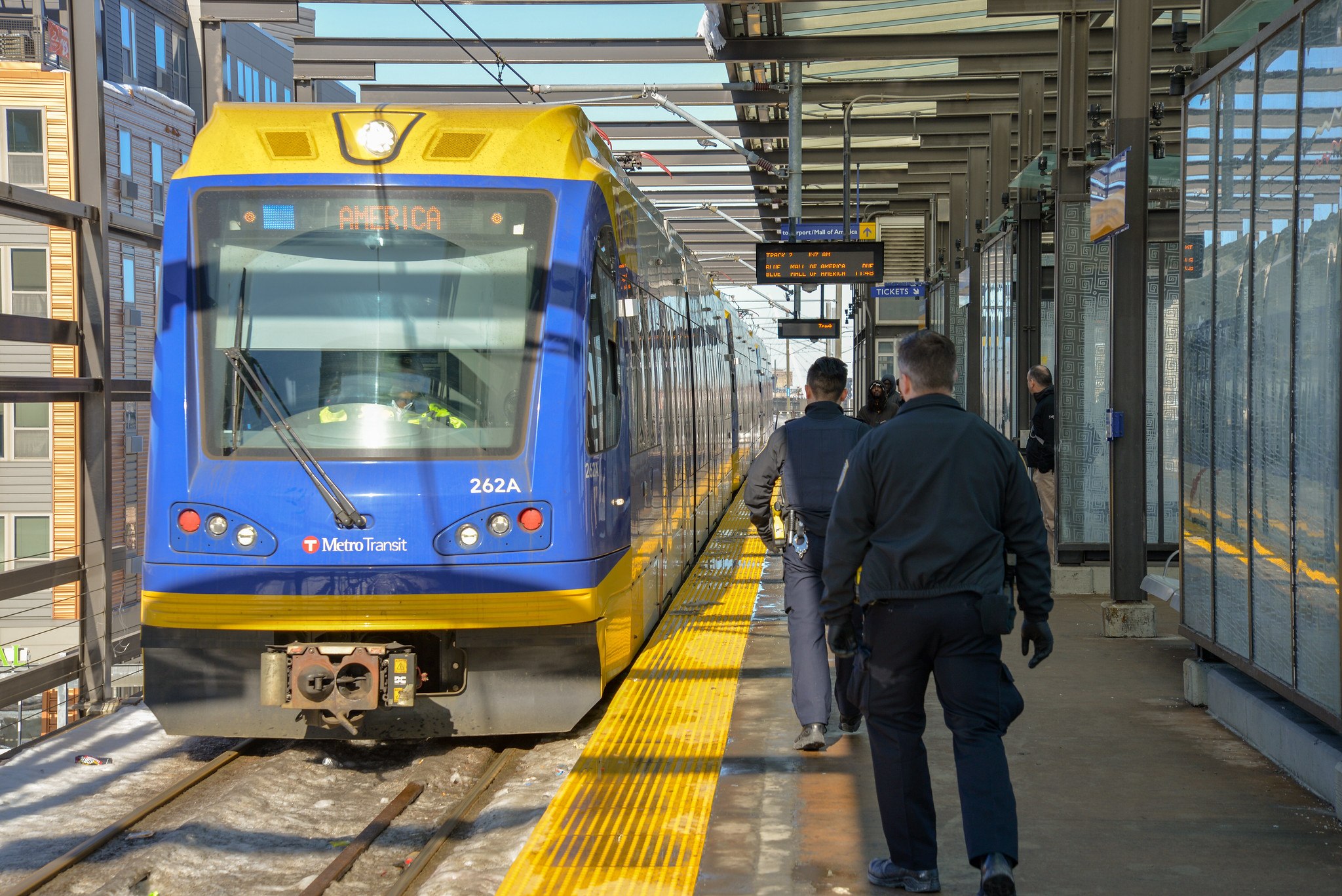 Police officers walk on the platform of the Lake Street/Midtown Station. 