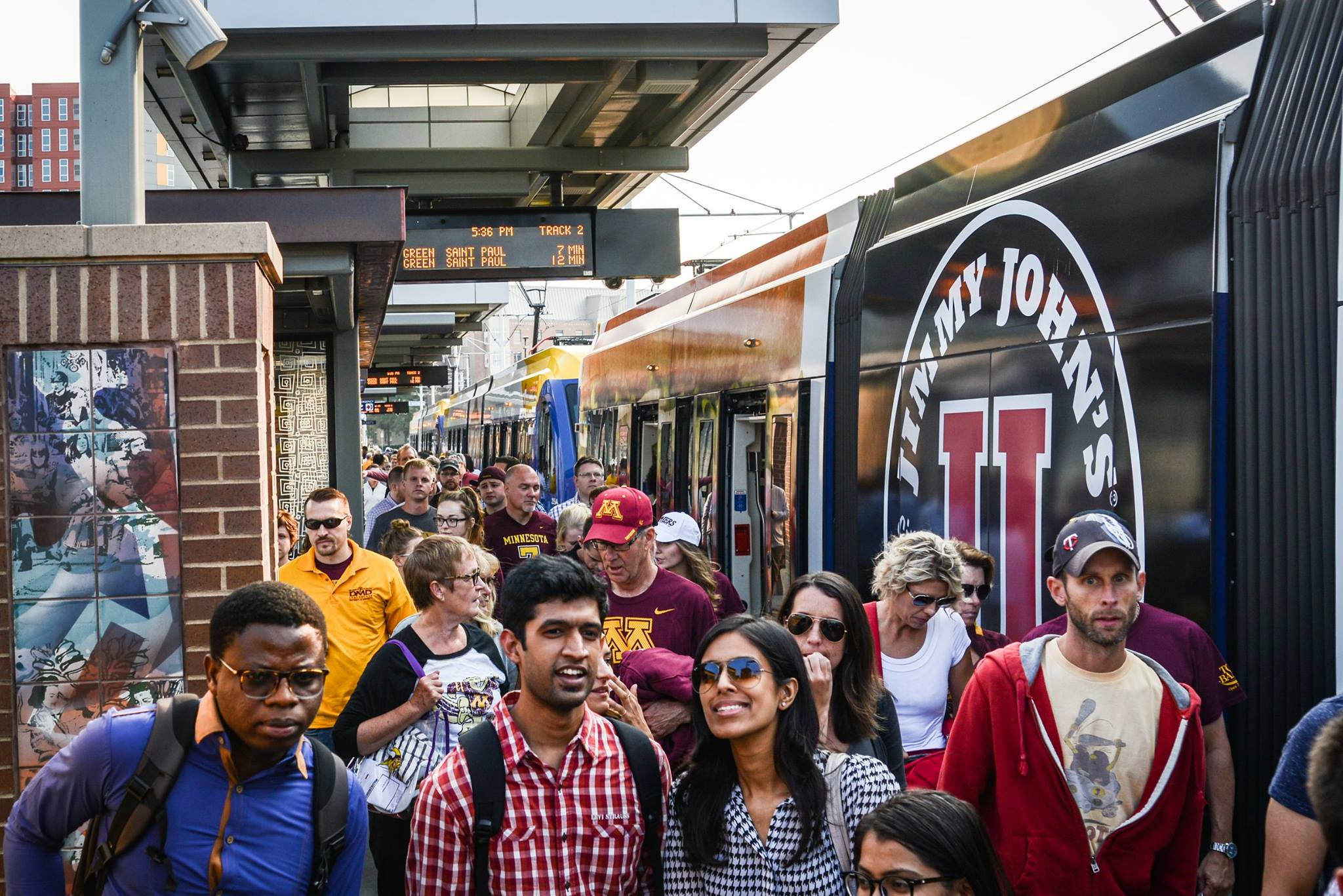 Passengers exit a Green Line train at Stadium Village Station in Minneapolis.