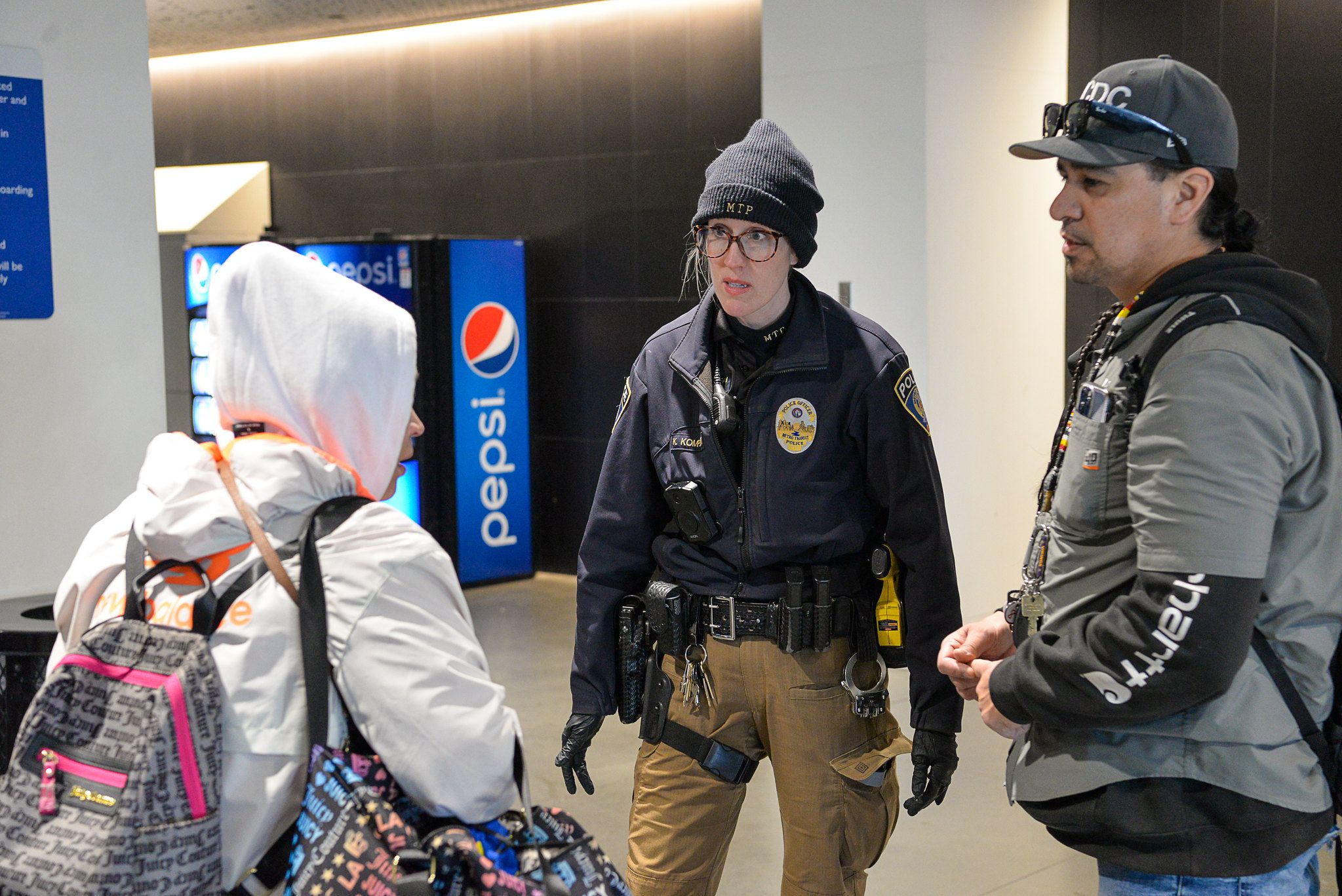 A Metro Transit police officer and community partner speak with a person at the Mall of America Transit Center. A Metro Transit police officer and community partner speak with a person at the Mall of America Transit Center.