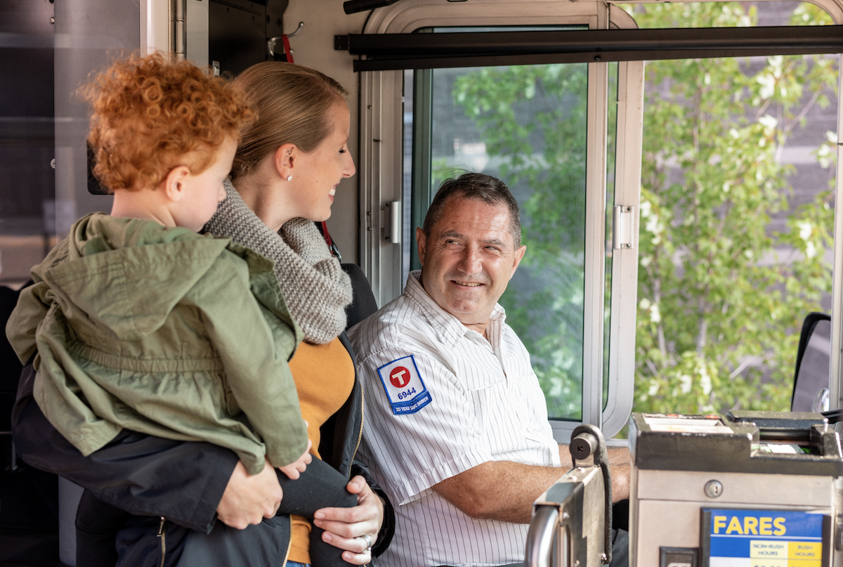 Mom and child getting on a bus.