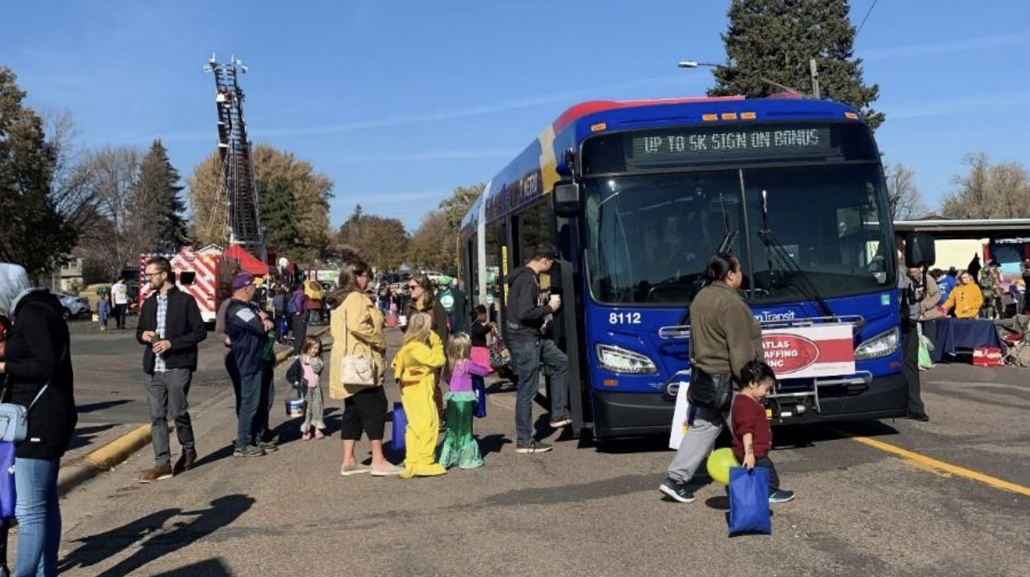 Photo of F people getting on and off a BRT bus at an F Line engagement opportunity in Columbia Heights