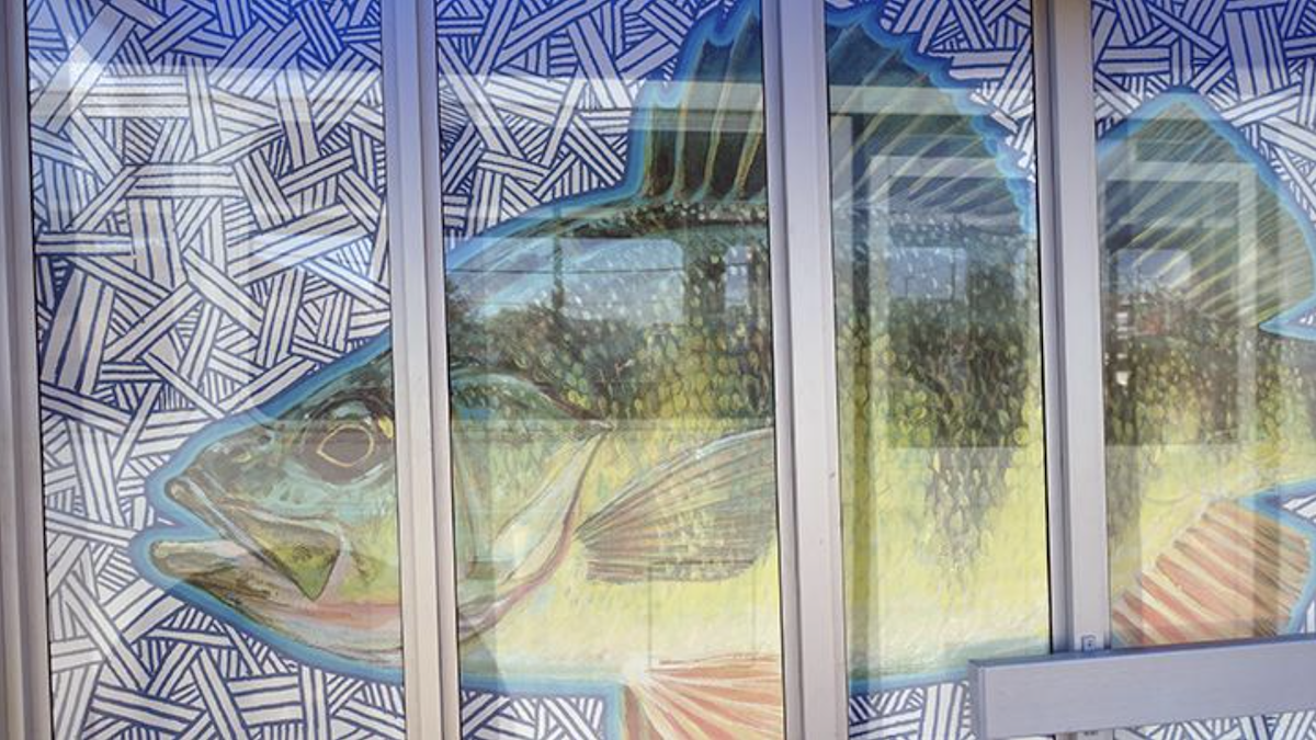 A picture containing building, window, fish art.