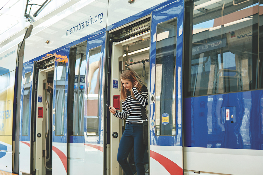 Woman getting off of the train.