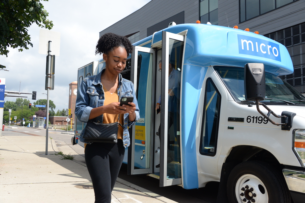 Woman exiting micro bus