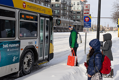 Customers boarding a bus in the snow