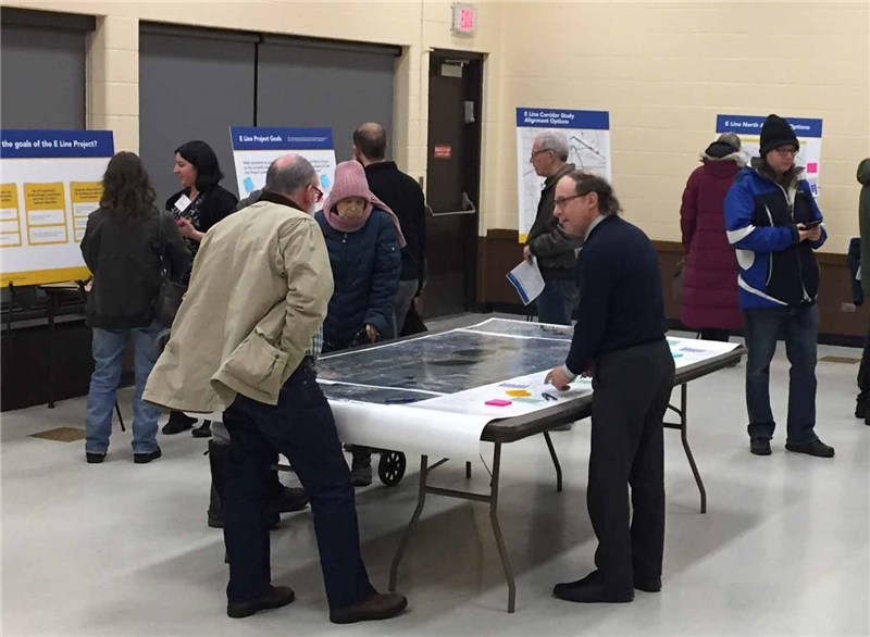 Photo of people discussing transit with planners