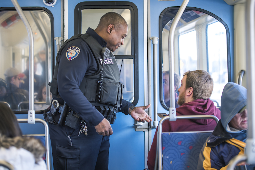 Metro Transit Police checking fares on a train.