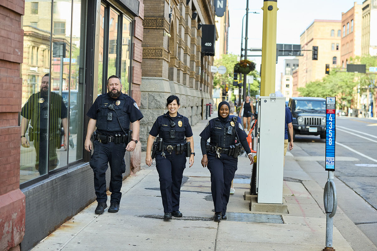 Three Transit Police officers walking down a street