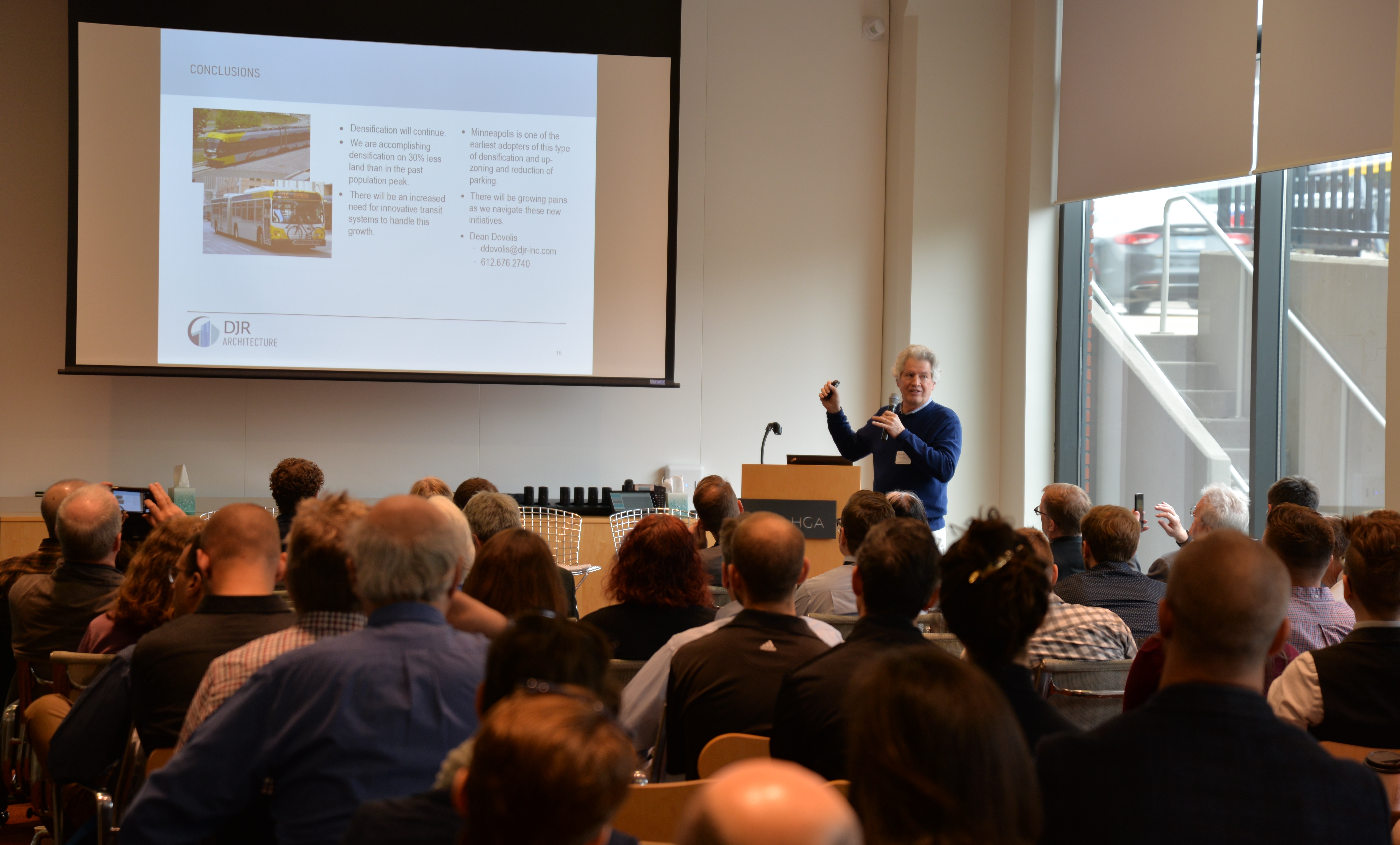 A presenter discusses a topic in front of a crowd at a TOD forum