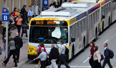 White bus with blue and yellow accents.